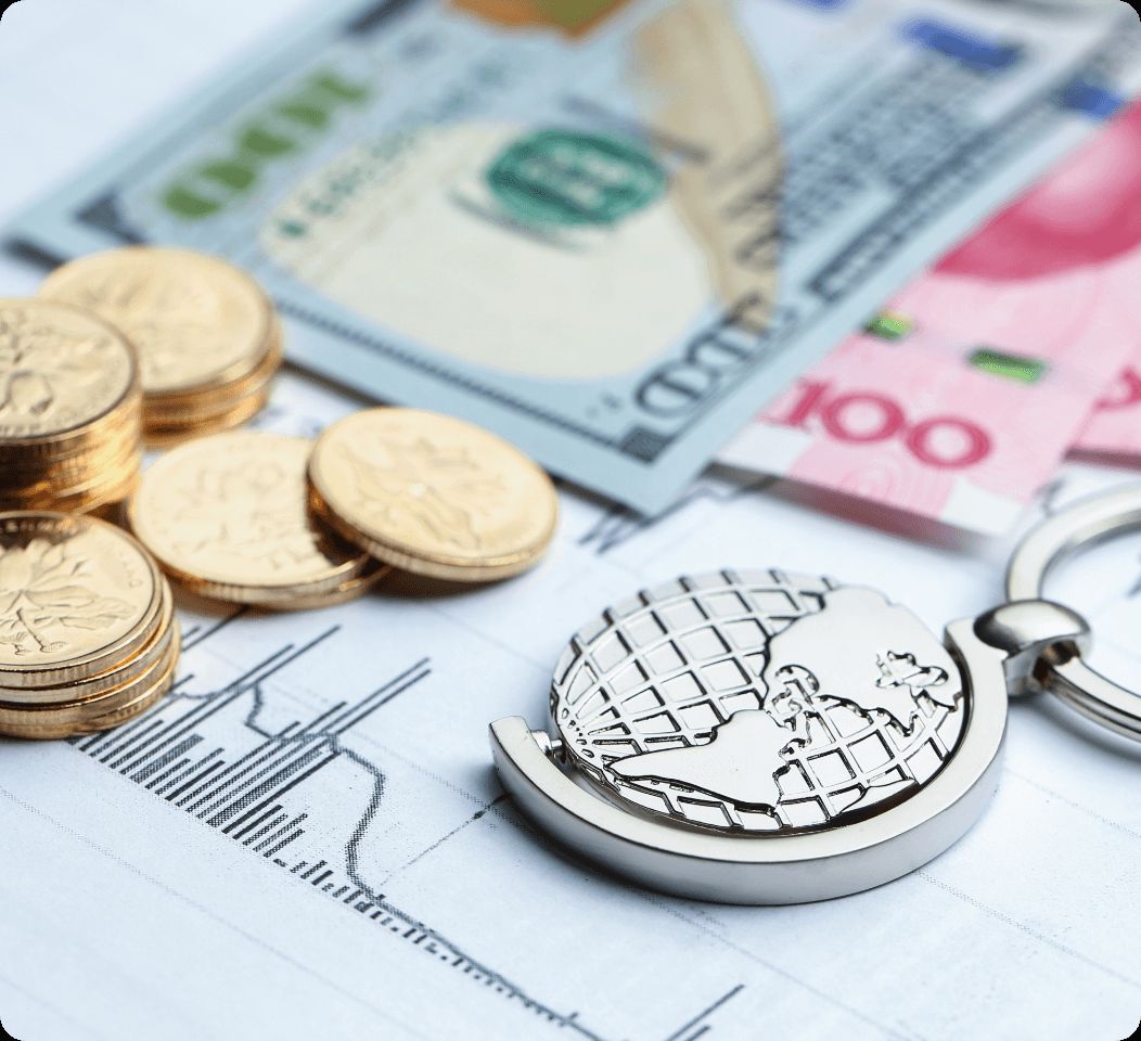 Foreign currency notes and coins resting on a printed exchange-rate chart