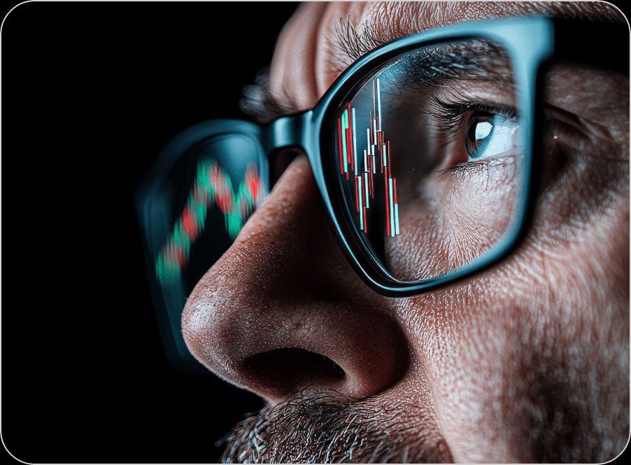 Close-up of a trader analyzing stock market charts reflected in their glasses