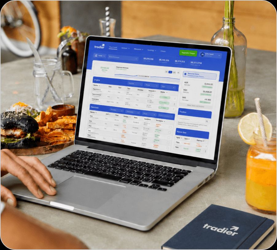 Tradier trading platform dashboard displayed on a laptop screen